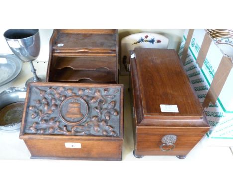 An early 19th Century mahogany tea caddy with lions mask ring handles, raised on bun feet, an early 20th Century oak tamber f