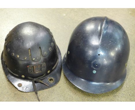 A miner's helmet and a French fireman's helmet 