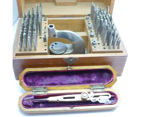 A watch staking tool and one other cased tool 