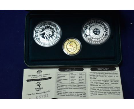 Sydney 2000 Olympic three-coin set, comprising: gold $100 with enamel detailing; and two silver $5 coins, in presentation cas