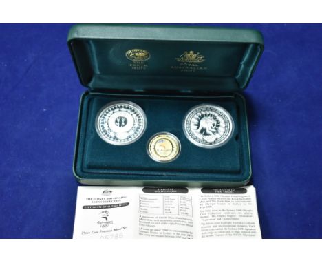 Sydney 2000 Olympic three-coin set, comprising: gold $100 with enamel detailing; and two silver $5 coins, in presentation cas