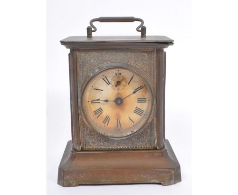 Junghans -&nbsp; A 19th century base metal carriage style clock with round Roman dial and glass side panels over a flared bas