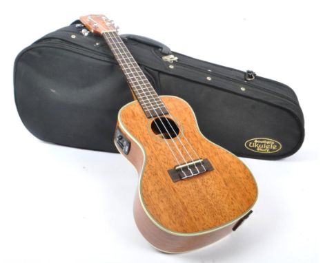 Kala - A Kala model KA-CGE cased concert electro ukulele. The ukulele having cream binding around a high gloss mahogany body,