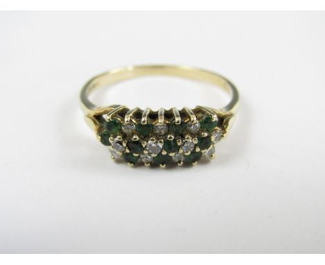 A diamond and emerald dress ring, the stones claw and crown set in a tiered diagonal arrangement over a trifurcating 9ct gold