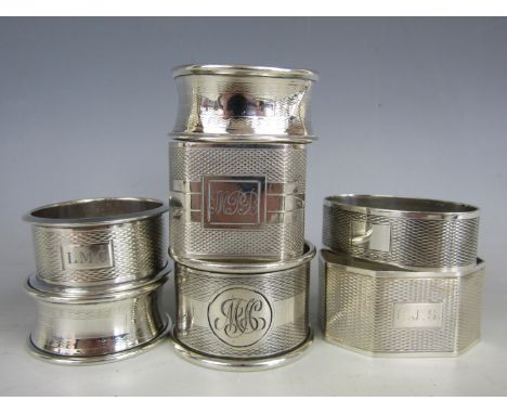 Selection of seven silver napkin rings each decorated with engine pattern
