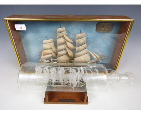 A glass ship-in-a-bottle depicting the SS Great Britain together with a cased scale model of the Cutty Sark