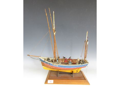 A hand built model boat of the Marie-Jeanne with figures to the deck 