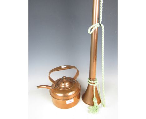 A copper hunting horn together with a copper kettle