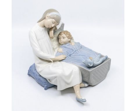 Nao figure of young girl next to son or brother in cot