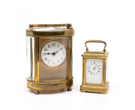 A late 19th / early 20th century French brass oval carriage clock, white circular enamel dial with Arabic numerals, R &amp; C
