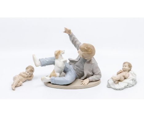 Three Nao figures including boy playing with dog and two young children figures