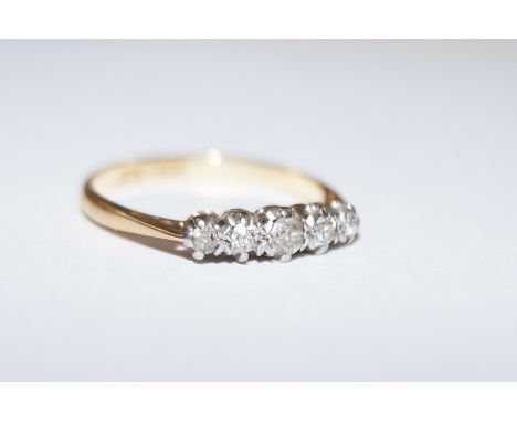 18 gold ring set with five diamonds, size O