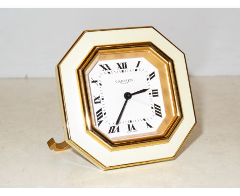 Cartier, Paris travel clock numbered 7507 13112. The clock is set on the signature "C" stand. Original soft Cartier case and 