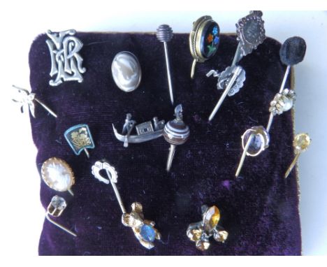 A collection of stick pins including one gold example.