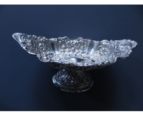 A late Victorian silver repousse canoe-shaped silver pedestal bowl - Mappin Brothers, London 1897,  10" across.