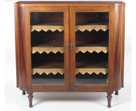 An attractive 19th Century Display Cabinet, the shaped top with inlaid border over glazed panel doors, the shelves with shape