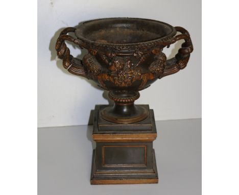 A 19th Century fine quality iron model of The Warwick Vase, with egg n' dart rim (some loss), embellished with various figure