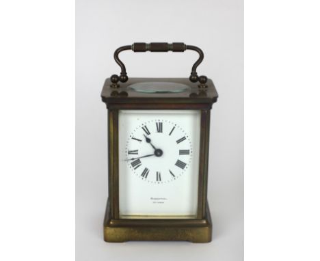 A small brass cased Carriage Clock, the white enamel dial with Roman numerals, and signed Rosenthal, Ottawa. (1)