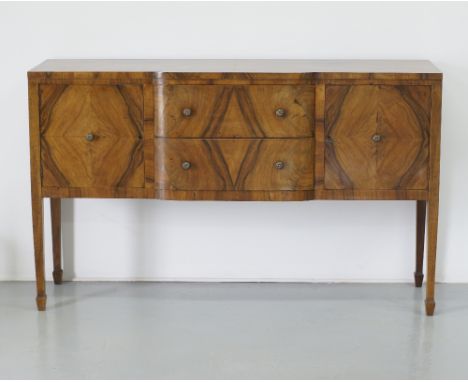 A Cypriot walnut console dresser / buffet, in Regency revival style, with two central drawers flanked by two quarter veneered