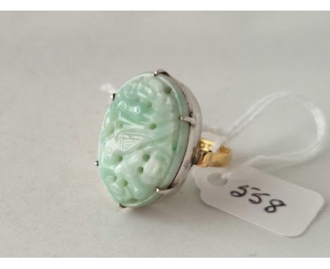 A large green jade ring, 22ct with white metal mount, size P, 10 g