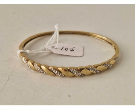 A DIAMOND BANGLE 9CT 9.3 GMS
