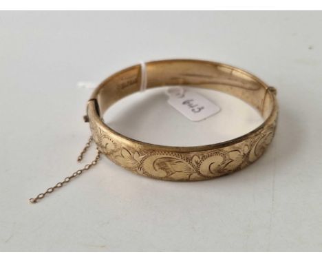 A rolled gold hinged bangle