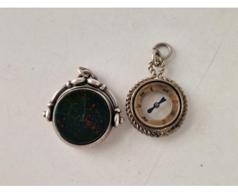 Two silver fobs, one a compass fob