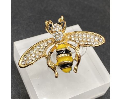 A pretty gem set and enamel bee brooch with gem set eyes