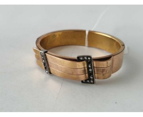 An antique rolled gold bangle, 4 pearls missing