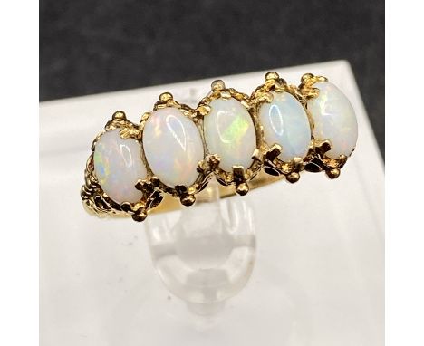 A vintage five stone opal ring, the fiery shows multi coloured flashes Size N