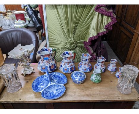 A graduated set of six 19th century Mason's Ironstone snake handled jugs and a similar Masons jug in green, a German figural 