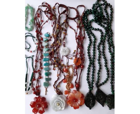 A quantity of modern Oriental jade and hard-stone costume jewellery, mainly necklaces, all housed in 5 fabric boxes and one o