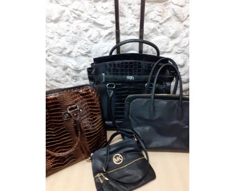 An Italian black faux crocodile print travel bag with integral folding trolley handle to the rear, a brown patent faux crocod
