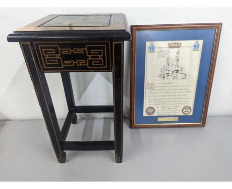 A small black lacquered and gilt wooden table with a drawer and chinoiserie decoration, along with a Nelson's prayer print, L