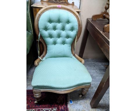 Victorian walnut upholstered nursing chair, button upholstered back, serpentine front, on turned front legs and ceramic casto