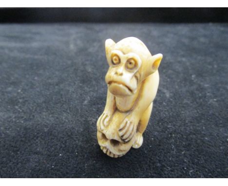 Ivory netsuke model of a thinking monkey