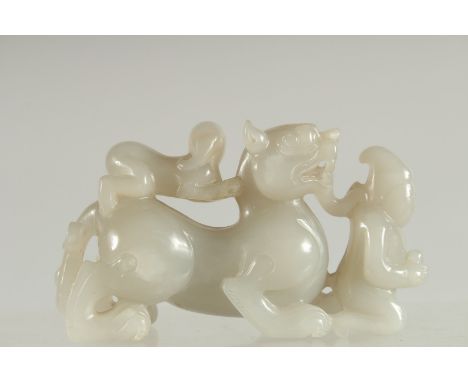 A CHINESE CARVED JADE KYLIN PAPERWEIGHT, 12cm long.