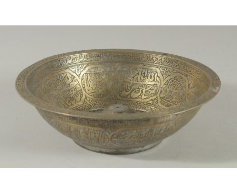 A 19TH CENTURY OTTOMAN BRASS MAGIC BOWL, with engraved calligraphic panels, 20.5cm diameter.