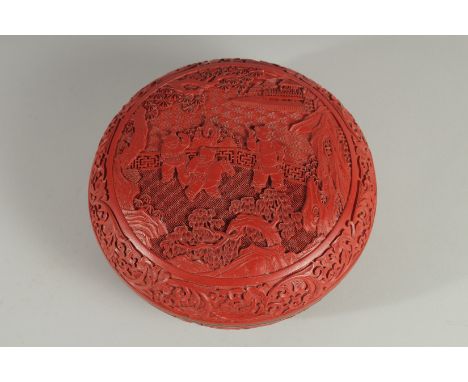 A CHINESE CINNABAR LACQUER CIRCULAR BOX AND COVER, the lid with panel depicting boys playing in a courtyard, 20.5cm diameter.