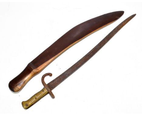 A 19th century French M1866 type bayonet, with brass grip, length 69cm, with a hardwood tribal club, length 65cm (2).Addition