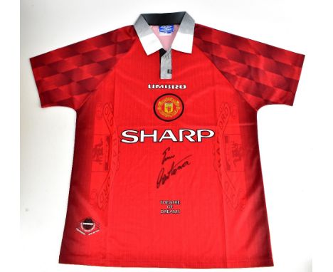 ERIC CANTONA; an Umbro 'Theatre of Dreams' Manchester United home shirt, signed to the front, size large.Additional Informati