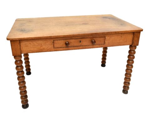 A 19th century oak writing table, with single frieze drawer raised on bobbin form supports, width 117cm, depth 69cm, height 7