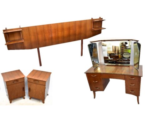 A mid-century four piece bedroom suite comprising a mirror back knee hole sideboard, with an arrangement of seven drawers, a 