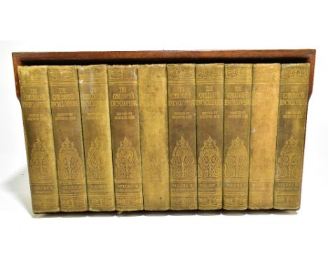 A shelf containing ten volumes of the Children's Encyclopedia edited by Arthur Mee.