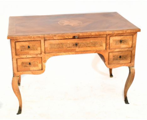 A 19th century Italian parquetry inlaid walnut and burr walnut desk, the quarter veneered top with central starburst detail a
