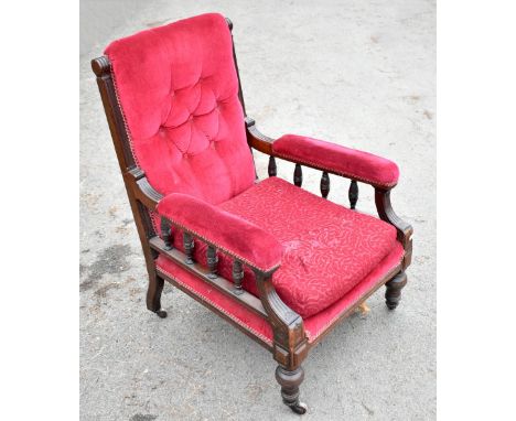 A late Victorian mahogany button back library chair raised on ring turned front legs.PROVENANCE: from the Brian Morley collec