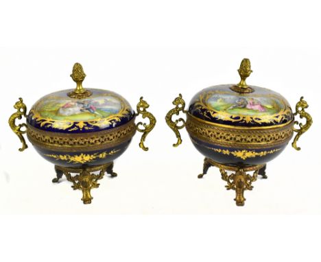 SEVRES: a pair of cache pots each with pineapple finial above twin vignettes to the lid painted with figures in landscapes wi