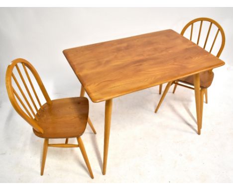 ERCOL; a light elm dining table with undertier spindle magazine shelf, raised on column support, height 73cm, width 97cm, dep