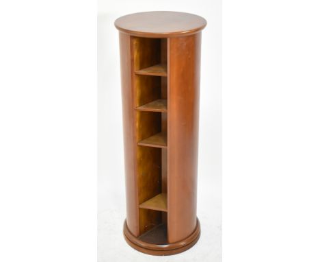 A contemporary cherry wood rotating cylinder CD/small book rack, height 100cm.
