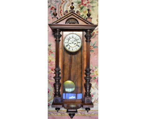 A walnut and stained beech Vienna regulator wall clock, the enamel dial with Roman numerals chapter ring and subsidiary secon